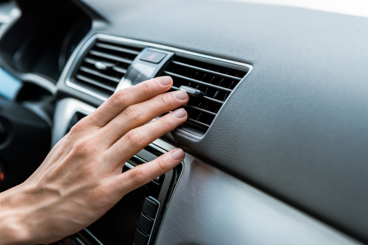 hand on car air conditioning vent